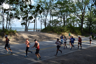 Erie Marathon Runners on the partially shaded beach side of the race course.