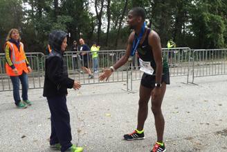 Erie Marathon Winner awarded his winner medal at the finish line.
