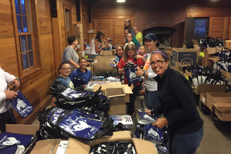 Erie Marathon Volunteers assembling race participant goodie bags.
