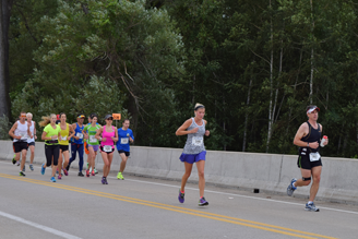 The Erie Marathon 8:15 pacer and group of racers cross the bridge near Perry Monument on Presque Isle near Erie, PA.