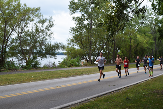 The Erie Marathon participating runners at bay side of the course enjoying views of the fresh water bay and downtown Erie.